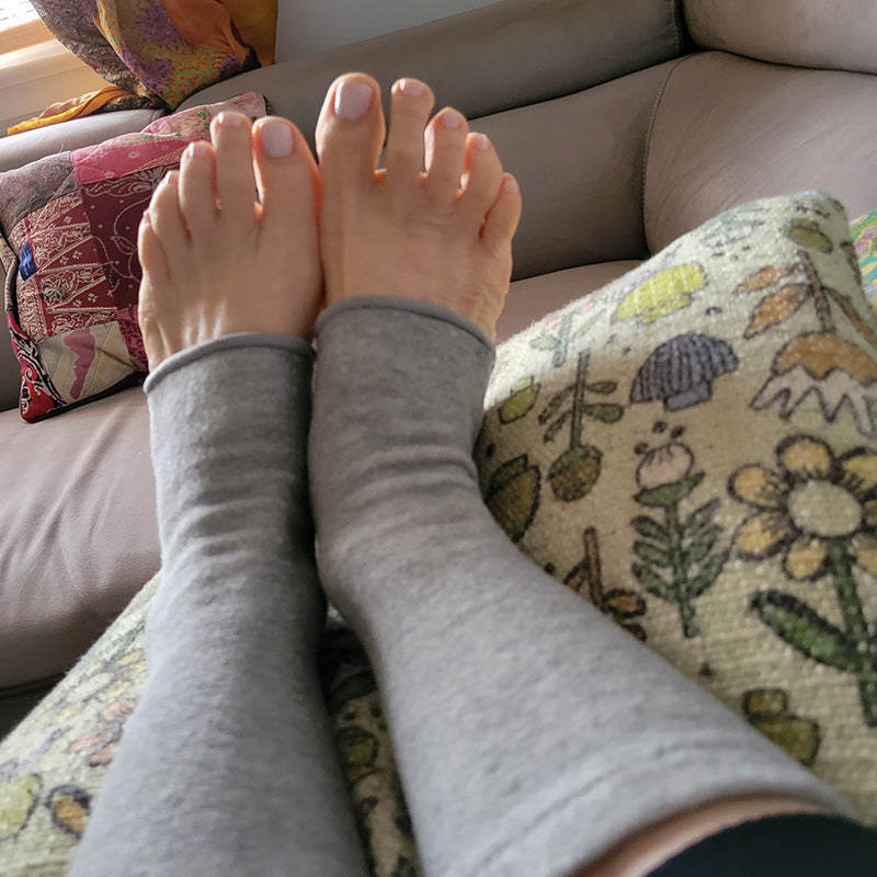Close-up of a grey compression knee sleeve worn for joint support, pain relief, and improved mobility.